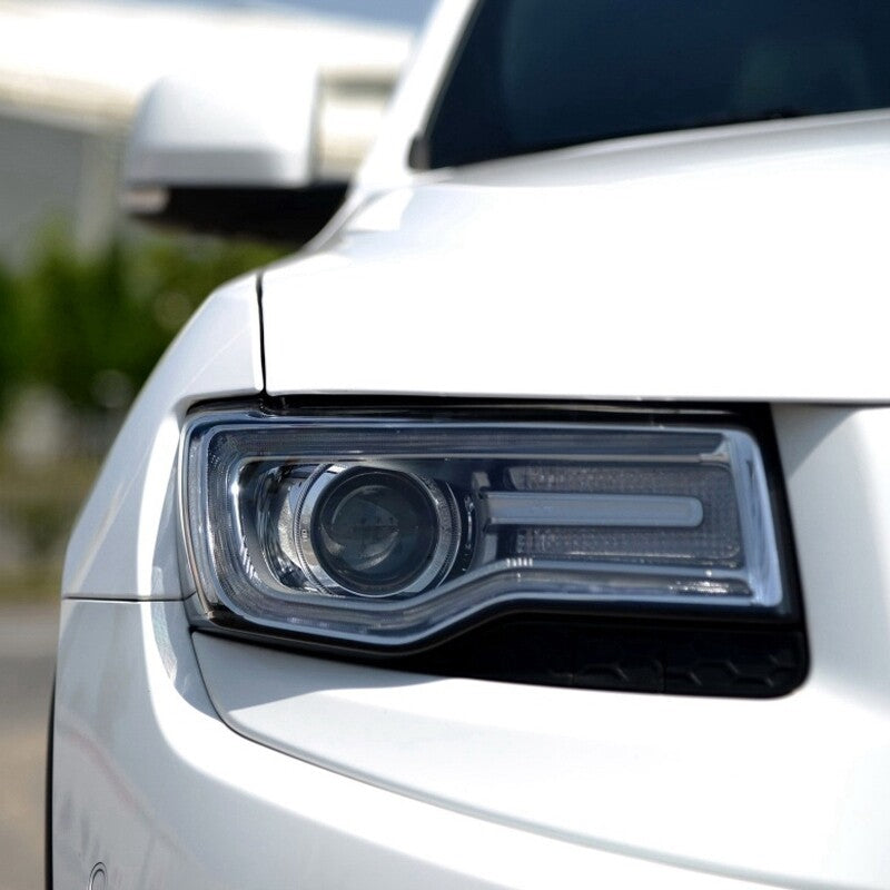 A pair of transparent headlight lens covers for Jeep Grand Cherokee 2014 - 2019